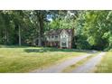Traditional two-story home with a spacious front yard and a long driveway at 12101 Ranburne Rd, Mint Hill, NC 28227