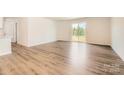 Bright living room with hardwood floors and sliding glass doors leading to the backyard at 149 Astor St, Troutman, NC 28166