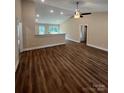 Open-concept living room boasts vaulted ceilings, wood flooring, and natural light from the sliding glass doors at 268 Hatley Ne Cir, Concord, NC 28025