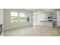 Open-concept living space with large windows, seamlessly connecting the living room and kitchen at 3029 Ora Smith Rd, Lincolnton, NC 28092