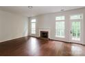 Spacious living room featuring a fireplace, hardwood floors, and large windows for ample natural light at 3422 Balsam Tree Dr, Charlotte, NC 28269