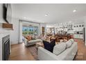 Open-concept living room flows into the modern kitchen and dining area at 5361 Mint Harbor Way # 0301, Charlotte, NC 28269