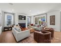 Bright living room with fireplace, hardwood floors, and sliding door to the patio at 5361 Mint Harbor Way # 0301, Charlotte, NC 28269