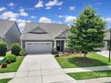 Beautiful home featuring a well-manicured lawn, two-car garage, and lovely front yard landscaping at 537 Lincoln Quarters Ln, Fort Mill, SC 29708