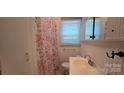 Cozy bathroom featuring a floral shower curtain and vanity with mirror at 1904 E Innes St, Salisbury, NC 28146
