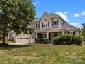 Inviting two-story home featuring a manicured lawn and a classic architectural design at 191 Harris Farm Rd, Mooresville, NC 28115