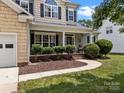 Beautiful home featuring a welcoming front porch with decorative shrubbery and landscaping at 191 Harris Farm Rd, Mooresville, NC 28115