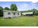 A cozy single-story home with vinyl siding and a metal carport visible from the side yard at 2321 Cline St, Statesville, NC 28677