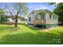 Side view showing access to the home and a metal carport, with a well-kept lawn at 2321 Cline St, Statesville, NC 28677