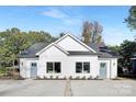 Charming duplex exterior featuring light blue doors, well-manicured landscaping, and a shared driveway at 3316 Cedarhurst Dr, Charlotte, NC 28269