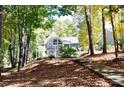 Secluded house nestled among trees with a pathway leading to the beautiful two-story home at 3645 Lake Bluff Dr, Sherrills Ford, NC 28763