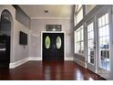 Elegant entryway with dark wood floors, double doors, and abundant natural light streaming through large windows at 3645 Lake Bluff Dr, Sherrills Ford, NC 28763
