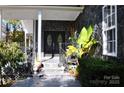 Charming front entrance with stone accents, wrought iron railing, and a welcoming covered porch at 3645 Lake Bluff Dr, Sherrills Ford, NC 28763