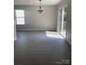 Open dining area with modern light fixture and view to sliding glass doors and balcony at 961 Poplar Forest Rdg, Clover, SC 29710
