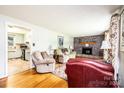 Inviting living room featuring a brick fireplace, hardwood floors, and a cozy seating arrangement at 1008 2Nd Se St, Conover, NC 28613