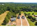 Aerial view of new homes on spacious lots with mature trees and a community pool at 1017 S Main St, Granite Quarry, NC 28146