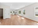 Bright, open-concept living room with wood floors and abundant natural light at 1017 S Main St, Granite Quarry, NC 28146