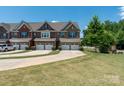 Charming townhome featuring attached garages, long driveway, well maintained lawns, and landscaping at 113 Burlingame Ct, Mooresville, NC 28117