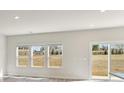 Lots of natural light flows through the three large windows and sliding glass door with views of backyard at 132 Satchel Ct, Mooresville, NC 28115