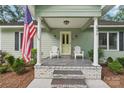 Welcoming front porch with white chairs, columns, and a bright yellow front door at 3770 Buck Point Rd, Catawba, NC 28609