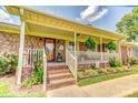 Close-up of a welcoming front porch with brick steps and decorative plants at 404 Baxter Rd, Cherryville, NC 28021