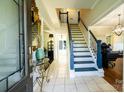 Inviting foyer with tile flooring, staircase with blue accents, and elegant decor at 9232 Chislehurst Rd, Mint Hill, NC 28227