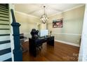 Bright home office with hardwood floors, modern desk, and stylish globe chandelier at 9232 Chislehurst Rd, Mint Hill, NC 28227