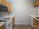 Efficient kitchen with wood cabinets, white appliances, and durable countertops at 3320 Hunting Wood Ct, Gastonia, NC 28052