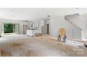 Unfinished living room featuring an open floor plan, light walls, and an exterior door at 4615 Yellow Poplar Ln, Concord, NC 28025