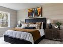Comfortable bedroom with stylish decor, featuring a black headboard and patterned pillows at 2230 Endeavor Run, Charlotte, NC 28269