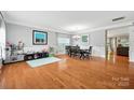Spacious room with hardwood floors includes a dining table and a play area with toy storage at 409 Bougainvillea Ct, Monroe, NC 28110
