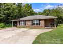 Classic brick single-story home with covered porch, black shutters, and large driveway at 508 Gantt St # 1-2, Kings Mountain, NC 28086