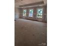 Unfinished living room featuring three windows offering ample natural light, awaiting final touches at 120 Canary Ln # 6, Mooresville, NC 28115