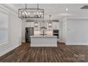 Modern kitchen featuring white cabinets, stainless steel appliances, and a stylish center island at 1312 Copper Leaf Dr, Rock Hill, SC 29732