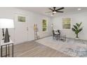 Bright living room with stylish gray flooring, a modern ceiling fan, and lots of natural light at 3015 Lasalle St, Charlotte, NC 28216