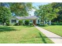 Inviting single-Gathering home with manicured lawn, mature trees, and a welcoming red front door at 630 4Th Nw Ave, Hickory, NC 28601