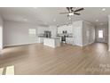 Bright, open-concept living space featuring hardwood floors and a modern kitchen at 7007 Jerimoth Dr, Charlotte, NC 28215