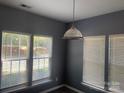Cozy dining area featuring large windows that flood the space with natural light at 7125 Flying Scotsman Dr, Charlotte, NC 28213