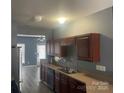 Modern kitchen featuring sleek appliances, dark wood cabinets, and ample counter space at 7125 Flying Scotsman Dr, Charlotte, NC 28213