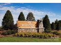 Community sign for Bailey Run with stone base, manicured landscaping, and bright blue sky background at 7221 Hodges Meadow Ln, Charlotte, NC 28213