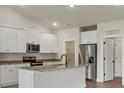 Bright kitchen with white cabinets, granite counters, stainless steel appliances, and kitchen island at 7315 Jerimoth Dr, Charlotte, NC 28215