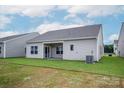 A spacious backyard features a covered patio, and lush green grass, perfect for outdoor activities at 7319 Jerimoth Dr, Charlotte, NC 28215