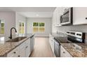 Modern kitchen with stainless steel appliances, granite countertops, and a large center island at 7319 Jerimoth Dr, Charlotte, NC 28215
