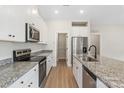 Bright kitchen featuring stainless steel appliances, granite counters, and ample cabinet space at 7319 Jerimoth Dr, Charlotte, NC 28215