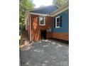 Exterior of home featuring brick foundation, stone pavers, and a secure side entry at 1320 Kings Cir, Shelby, NC 28150