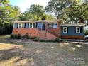 Well-maintained home featuring brick accents, black shutters, and a landscaped front yard at 1320 Kings Cir, Shelby, NC 28150