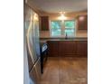Modern kitchen with stainless steel appliances, granite countertops, and brown cabinets at 1320 Kings Cir, Shelby, NC 28150
