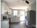 Bright kitchen with stainless fridge, sleek cabinets, and access to the back door at 1732 Rocky River Rd, Lancaster, SC 29720