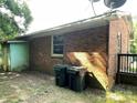 View of the back exterior with green utility boxes and a small deck at 28 Maiden Ln, York, SC 29745