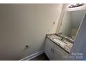 Modern powder room featuring granite countertop, stylish vanity, and neutral color palette at 307 Messner St, Salisbury, NC 28144